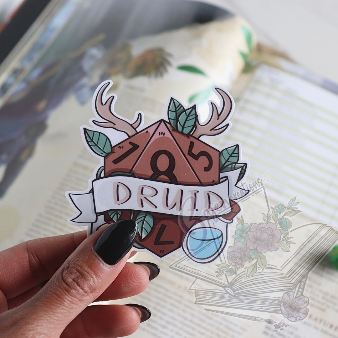 Sticker with 'Druid' design held by a hand on a book background