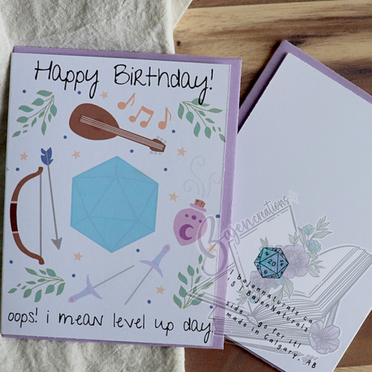 Birthday card with gaming elements and text on a wooden surface