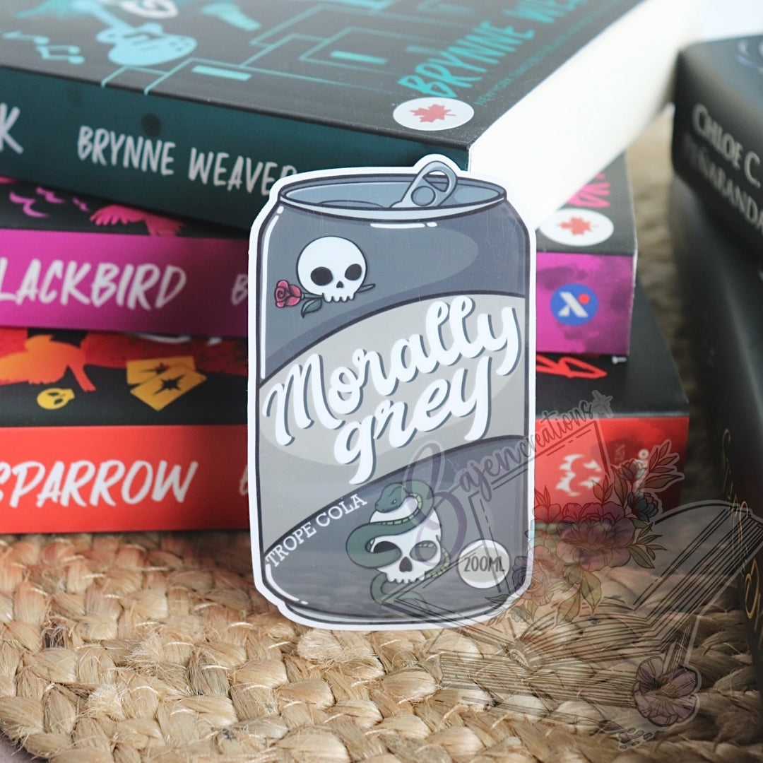 Sticker of a can labeled 'Morally Grey' on a textured surface with books in the background.