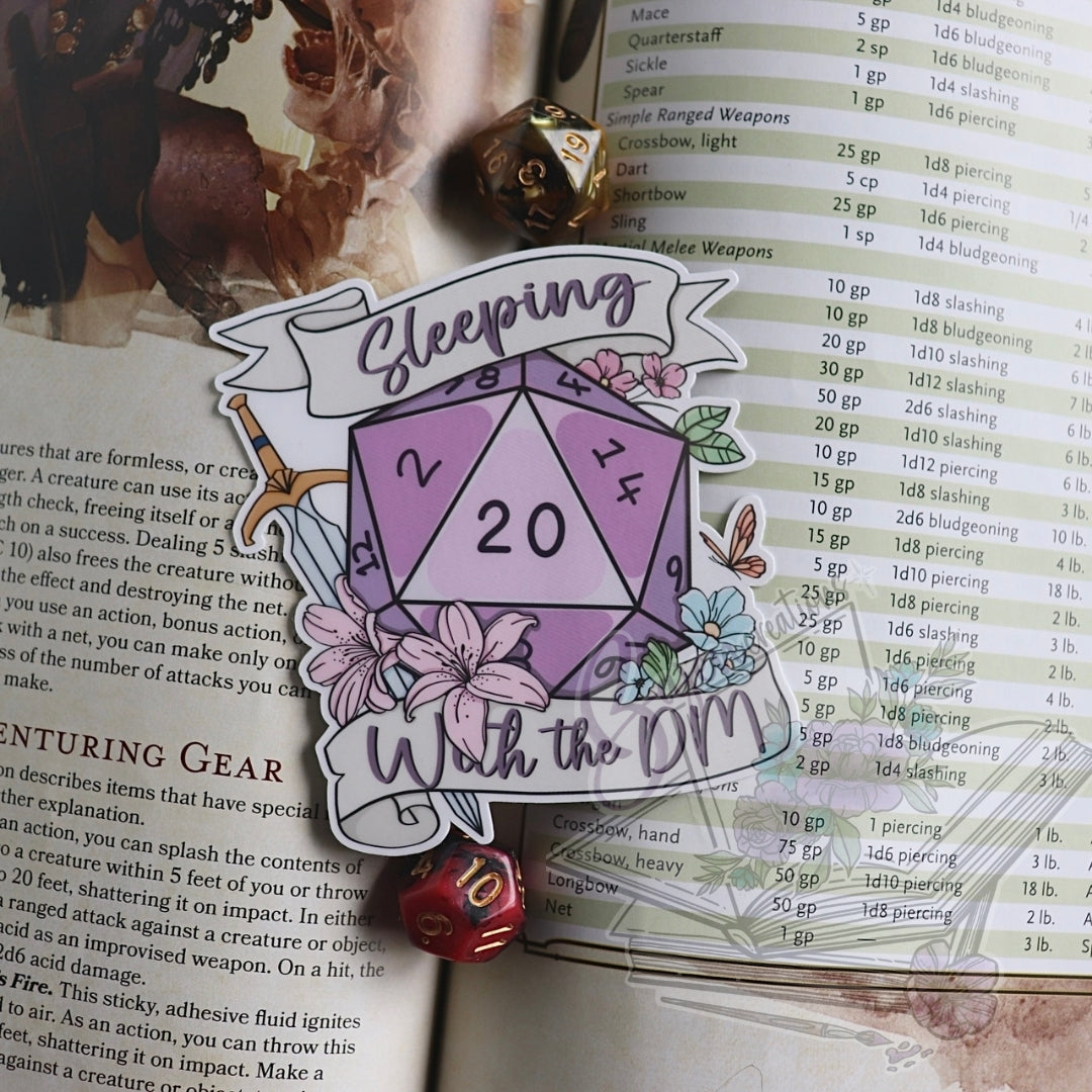 D20 die with flowers and text 'Sleeping with the DM' on a game rulebook background